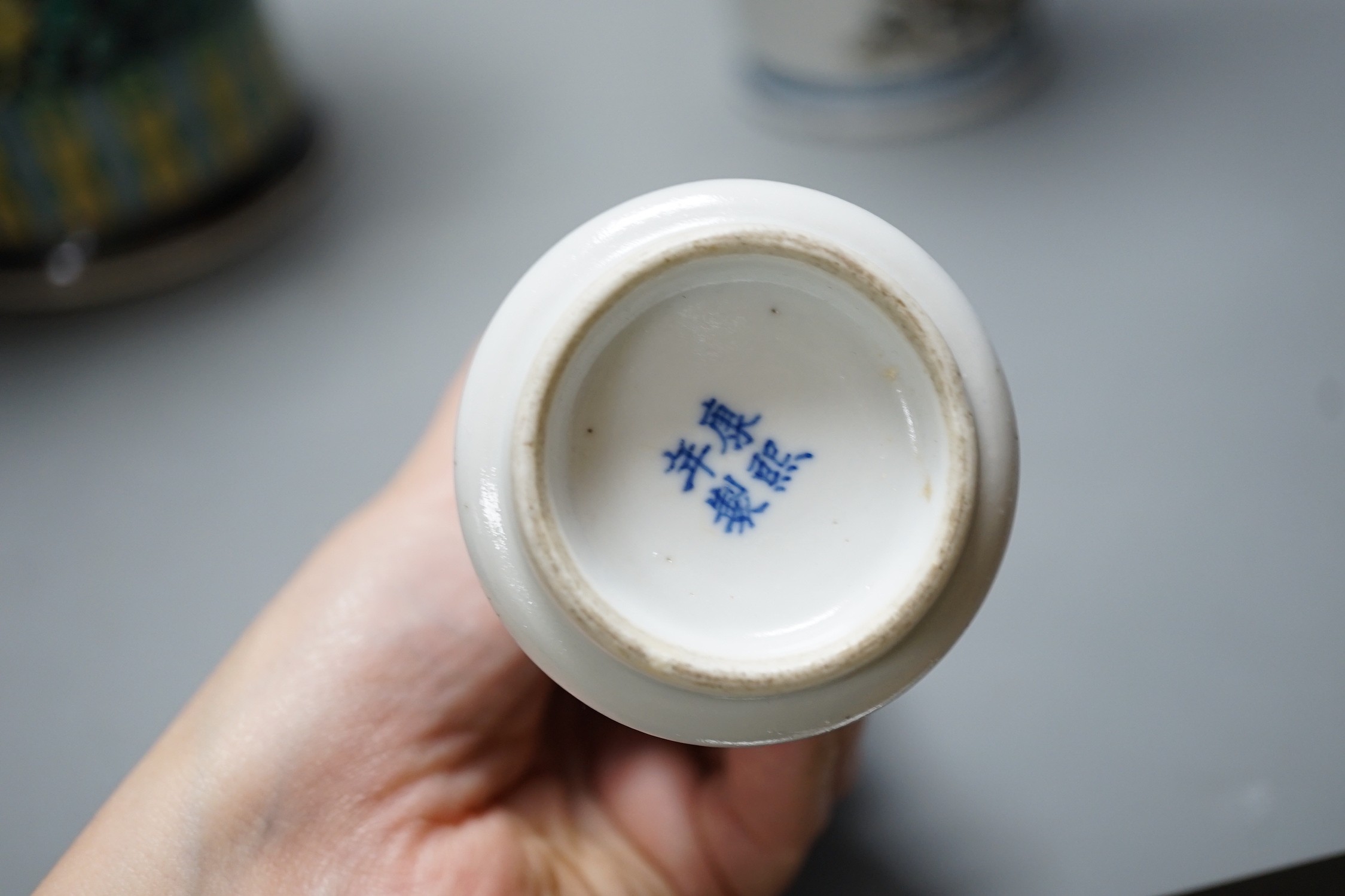 A Chinese famille noire vase, a Chinese blue and white small gu vase and a Japanese cylindrical vase, tallest 43cms high